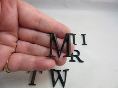 13 black plastic letters. Random mix