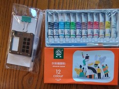 Mini travel gouache set featuring 12 tubes of paint, a small mixing palette
